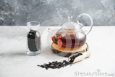 A glass teapot with dried loose teas and a wooden spoon Stock Photo