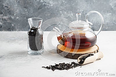 A glass teapot with dried loose teas and a wooden spoon Stock Photo