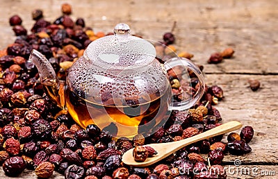 Glass Teapot of Herbal Dog Rose Tea With Dried Rosehips, Types Rosa Canina Hips Hot Drink of Medicinal Plants and Herbs Wooden Stock Photo