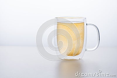 Glass thermo mug of water-soluble effervescent orange tablet on a white background Stock Photo