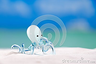 Glass tropical sea octopus on white beach sand Stock Photo