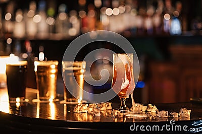 glass of unfiltered draft golden foam beer with on the bar counter Stock Photo