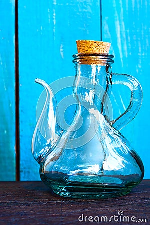 A glass vintage oiler on the blue background Stock Photo