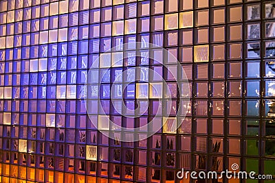 Illuminated glass wall from a office building Stock Photo
