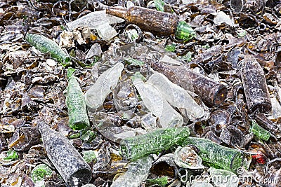 Glass waste in recycling facility. Brown and green bottles. Stock Photo