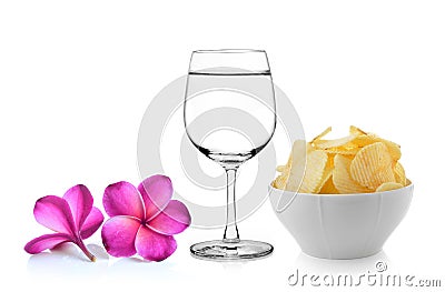 Glass of water frangipani flower , Bowl of potato chips Stock Photo