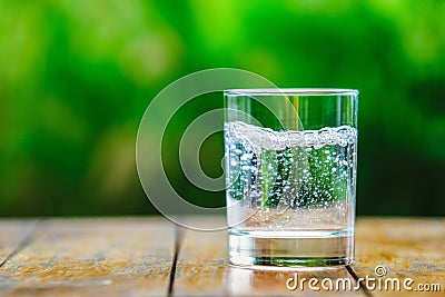 A glass of water on green background Stock Photo