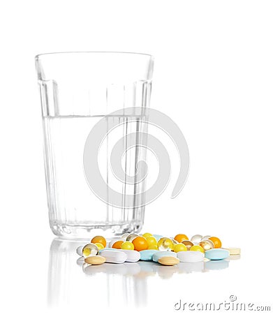 Glass with water and a heap of tablets, pills Stock Photo