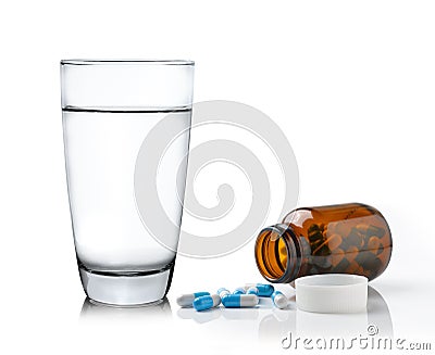 Glass of water Medicine bottle and pills isolated on white background Stock Photo