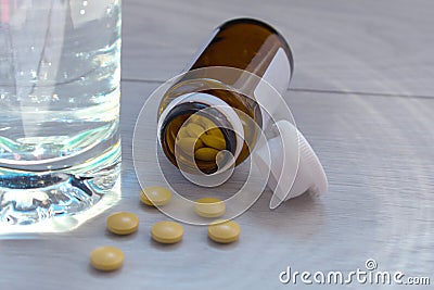 Glass of water and pills on the table Stock Photo