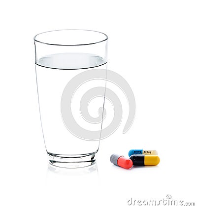 Glass of water and pills capsules Stock Photo