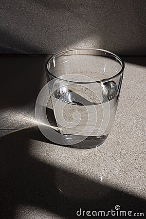 Glass of water with it's reflection (vertical version) Stock Photo