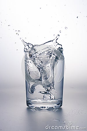 Glass of water with splash Stock Photo