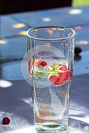Glass of water with strawberries Stock Photo