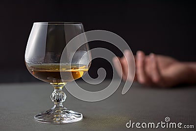 Glass of whiskey hand of a drunk man Stock Photo