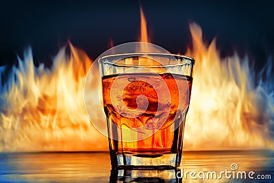 Glass of Whiskey over burning flames background Stock Photo