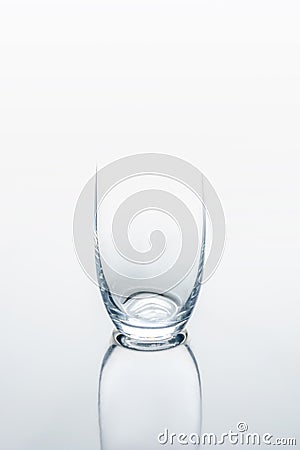 Glass on white reflecting table Stock Photo