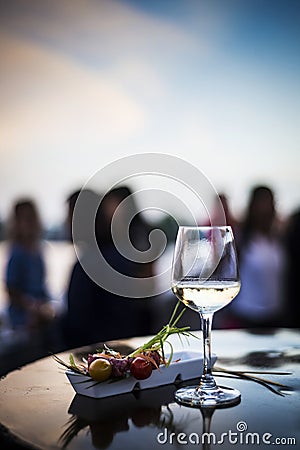 Glass of white wine with gourmet food tapa snacks outside Stock Photo