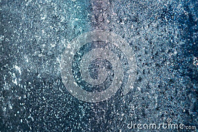 On glass window frost abstract patterns. Shimmer in different colors. White, purple, blue, celadon, pink. Winter, cold. Strong fro Stock Photo