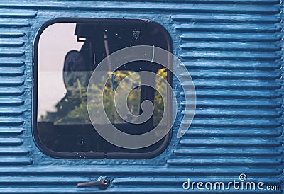 Glass window of old vintage train with blue container abstract travel background Stock Photo