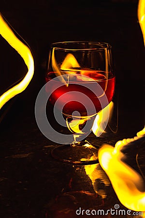 A glass of wine on a black background. Party club entertainment. Stock Photo