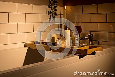 Glass of wine and candles on the bathtub tray Stock Photo