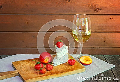 Glass of wine and cheese with blue mold with strawberries and nectarines Stock Photo