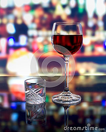 A glass of wine and a shot of vodka Stock Photo