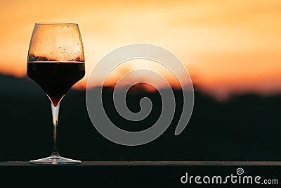 Glass of wine on sunset Stock Photo