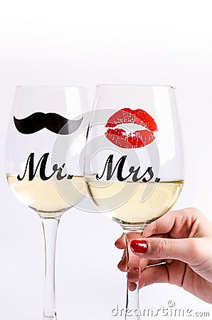 Glass of wine with womanÂ´s hand on a white background. Glasses for woman and man. White wine. Happy lifestyle. Romantic. Stock Photo