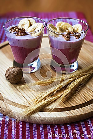 A glass of yogurt with blueberries, cereals, banana and walnuts Stock Photo