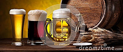 Glasses of beer and beer cask on the wooden table. Craft brewery Stock Photo