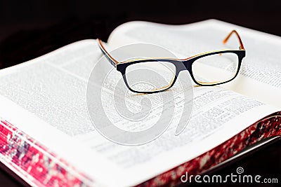 Glasses on the book of Talmud. Background Torah study Stock Photo