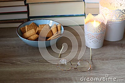 Glasses, Biscuits, Candles and Books Stock Photo