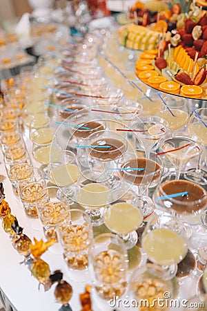 Glasses champagne on table served for buffet catering party outdoors, close up Stock Photo