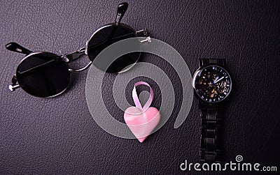 glasses and clock in the style of steampunk with a pink heart in the center on a black background Stock Photo