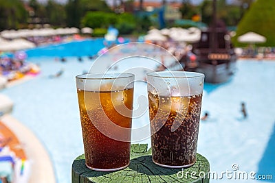 Glasses with cola and ice at the pool Stock Photo