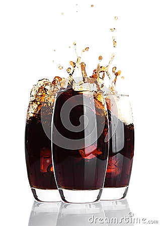 Glasses of cola with splash and ice cubes on white Stock Photo