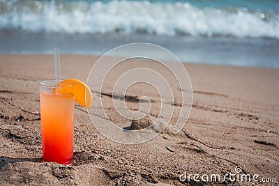 Glasses with colored cocktails on the beach Stock Photo