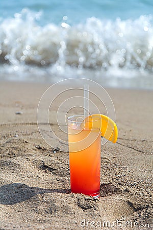 Glasses with colored cocktails on the beach Stock Photo