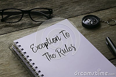 Glasses,compass,pen and notebook written with Exception to the rules on wooden background Stock Photo