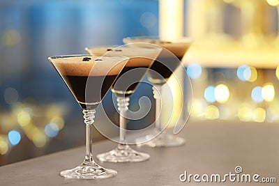 Glasses of delicious Espresso Martini on bar counter Stock Photo