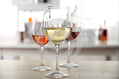 Three glasses with wine on kitchen table Stock Photo
