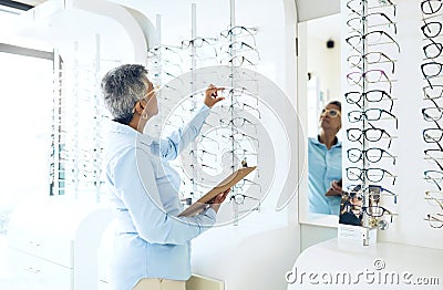 Glasses, eye care or senior woman with retail in store for checklist stock, inventory or eyewear choice. Vision Stock Photo