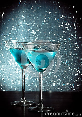 Glasses of fresh blue cocktail with ice on bar table Stock Photo