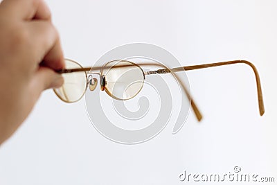 Glasses in a gold frame with diopters in hand Stock Photo