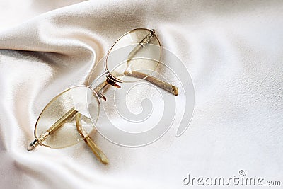 Glasses in a gold frame with diopters on a silk background Stock Photo