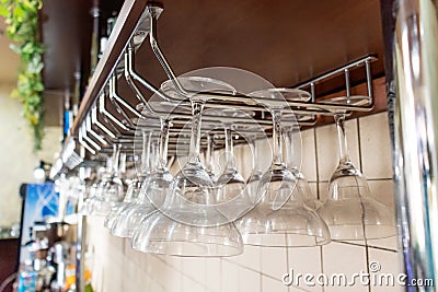 Glasses hang over the bar selective focus. barware. Stock Photo