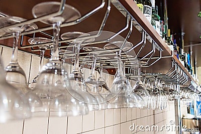 Glasses hang over the bar selective focus. barware. Stock Photo