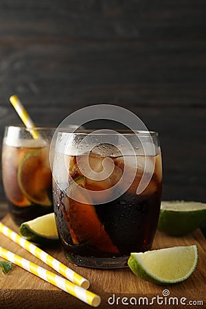 Glasses with ice cola, lime slices and tubules Stock Photo